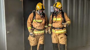 Open Circuit Breathing Apparatus Training showing two people coming out of a smoke room with fire fighter PPE