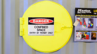 Confined Space Entry Training door showing danger and entry by permit only sign.