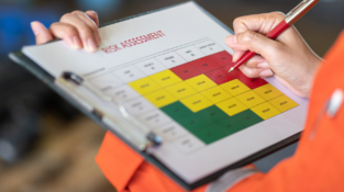 Risk Assessment and Job Safety Analysis table on a clipboard showing an active risk assessment